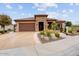 Single-story home with stone accents and beautifully landscaped front yard at 26702 W Sierra Pinta Dr, Buckeye, AZ 85396