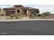 Single-story home with stone accents and beautifully landscaped front yard at 26702 W Sierra Pinta Dr, Buckeye, AZ 85396