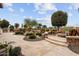 Relaxing fire pit with stone seating and lush landscaping at 26702 W Sierra Pinta Dr, Buckeye, AZ 85396