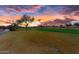Scenic sunset view of a lush green golf course at 26702 W Sierra Pinta Dr, Buckeye, AZ 85396