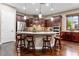 Island kitchen with dark wood cabinets and granite countertops at 26702 W Sierra Pinta Dr, Buckeye, AZ 85396