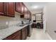 Laundry room with washer, dryer, cabinets, and granite countertop at 26702 W Sierra Pinta Dr, Buckeye, AZ 85396