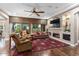 Spacious living room with a fireplace and built-in shelving at 26702 W Sierra Pinta Dr, Buckeye, AZ 85396