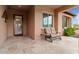 Covered porch with tile flooring and a small seating area at 26702 W Sierra Pinta Dr, Buckeye, AZ 85396