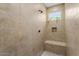 Large walk-in shower with built-in seat and window at 26702 W Sierra Pinta Dr, Buckeye, AZ 85396