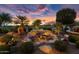 Landscaped backyard with a multi-tiered water feature at 26702 W Sierra Pinta Dr, Buckeye, AZ 85396