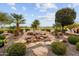 Serene backyard water feature with lush landscaping at 26702 W Sierra Pinta Dr, Buckeye, AZ 85396