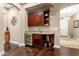 Convenient wet bar with wine cooler and custom cabinetry at 26702 W Sierra Pinta Dr, Buckeye, AZ 85396
