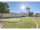 Landscaped backyard with putting green, pool, and pergola at 3121 E Hackamore St, Mesa, AZ 85213