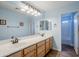 Double vanity bathroom with light blue walls and a tub at 3121 E Hackamore St, Mesa, AZ 85213