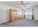 Bright bedroom with ceiling fan and built-in wall unit at 3121 E Hackamore St, Mesa, AZ 85213