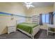 Bright bedroom with a double bed and built-in shelving at 3121 E Hackamore St, Mesa, AZ 85213
