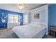 Bedroom with a full-size bed and blue walls at 3121 E Hackamore St, Mesa, AZ 85213