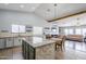 Open concept kitchen with island and view of living area at 3121 E Hackamore St, Mesa, AZ 85213