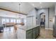 Open concept kitchen with island and view of living area at 3121 E Hackamore St, Mesa, AZ 85213