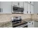 Modern kitchen features stainless steel appliances and granite countertops at 3121 E Hackamore St, Mesa, AZ 85213