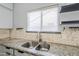 Clean kitchen with granite countertops and double stainless steel sink at 3121 E Hackamore St, Mesa, AZ 85213