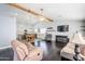 Open living room features dark hardwood floors, a ceiling fan, and an open kitchen concept at 3121 E Hackamore St, Mesa, AZ 85213