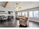 Bright living room with hardwood floors, fireplace, and large windows at 3121 E Hackamore St, Mesa, AZ 85213