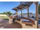Outdoor kitchen with built-in grill and pergola at 3121 E Hackamore St, Mesa, AZ 85213