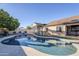Inviting kidney-shaped pool with surrounding patio at 3121 E Hackamore St, Mesa, AZ 85213