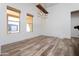 A dining room with large windows and a rustic wood chandelier at 43512 N 16Th St, New River, AZ 85087