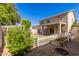 Spacious backyard with covered patio, swing, garden beds, and green landscaping at 6512 W Eagle Talon Trl, Phoenix, AZ 85083