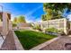 Green backyard with garden, greenhouse, and white fence at 6512 W Eagle Talon Trl, Phoenix, AZ 85083