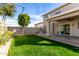 Spacious backyard with grassy area, covered patio, and swing at 6512 W Eagle Talon Trl, Phoenix, AZ 85083