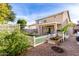 Landscaped backyard with a patio, garden, and white fence at 6512 W Eagle Talon Trl, Phoenix, AZ 85083