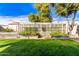 Landscaped backyard featuring a large greenhouse and garden at 6512 W Eagle Talon Trl, Phoenix, AZ 85083