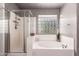 Serene bathroom includes a separate shower, soaking tub, and privacy window, creating a spa-like retreat at 6512 W Eagle Talon Trl, Phoenix, AZ 85083