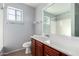 Bathroom with wood cabinets and a large mirror at 6512 W Eagle Talon Trl, Phoenix, AZ 85083