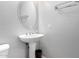 Powder room with pedestal sink and oval mirror at 6512 W Eagle Talon Trl, Phoenix, AZ 85083