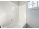 Clean bathroom with a white tub and gray walls at 6512 W Eagle Talon Trl, Phoenix, AZ 85083