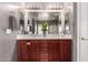 Bathroom features dual sinks, a large mirror, cherry cabinetry and modern fixtures at 6512 W Eagle Talon Trl, Phoenix, AZ 85083