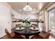 Cozy dining area featuring a round table set for four, adjacent to a bright and modern kitchen space at 6512 W Eagle Talon Trl, Phoenix, AZ 85083