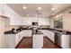 Modern kitchen featuring white cabinetry, granite countertops, and stainless steel appliances, perfect for culinary enthusiasts at 6512 W Eagle Talon Trl, Phoenix, AZ 85083