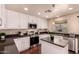 Well-lit kitchen features white cabinets, stainless steel appliances, granite countertops, and a center island at 6512 W Eagle Talon Trl, Phoenix, AZ 85083