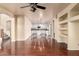 Spacious living room with hardwood floors and built-in shelving at 6512 W Eagle Talon Trl, Phoenix, AZ 85083
