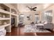 Cozy living room with modern furnishings, decorative shelving, and large windows, creating a comfortable and stylish living space at 6512 W Eagle Talon Trl, Phoenix, AZ 85083