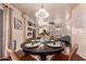 Cozy dining area with a round table set for four, with views into the living room and kitchen at 6512 W Eagle Talon Trl, Phoenix, AZ 85083