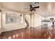 Open living room with hardwood floors and view of kitchen and stairs at 6512 W Eagle Talon Trl, Phoenix, AZ 85083