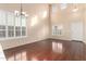 High ceiling living room with hardwood floors and two windows at 6512 W Eagle Talon Trl, Phoenix, AZ 85083