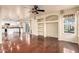 Bright living room, hardwood floors, kitchen view, and backyard access at 6512 W Eagle Talon Trl, Phoenix, AZ 85083