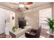 Stylish office with wood-look floors, modern desk, and sliding barn door leading to closet at 6512 W Eagle Talon Trl, Phoenix, AZ 85083