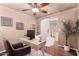 Comfortable office space with wooden floors, desk, a soft chair, and decor accents at 6512 W Eagle Talon Trl, Phoenix, AZ 85083