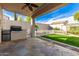 Flagstone patio with built-in grill and seating area at 6512 W Eagle Talon Trl, Phoenix, AZ 85083