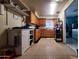 Galley kitchen with wood cabinets and laundry access at 6616 N 54Th Dr, Glendale, AZ 85301