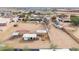 An overhead view of a large property with horse facilities, mature trees and white fencing at 9120 E Dennis St, Mesa, AZ 85207